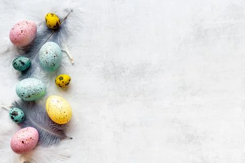 Layout of colorful Easter eggs and birds feather, top view Stock Photos