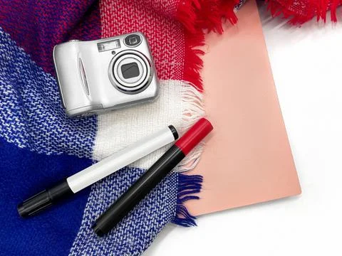 The layout consists of a camera, felt-tip pens, a notebook and a plaid. Stock Photos