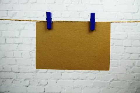 Layout of Empty paper space for text hanging on the wall with Clothespins o.. Stock Photos