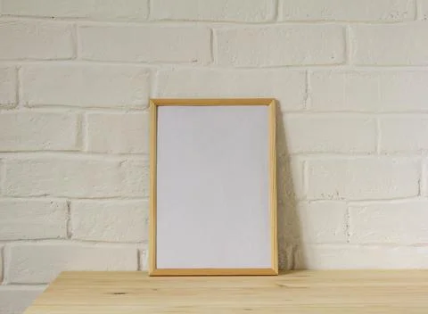 Layout of an empty photo frame or a picture on a table with a copy of the pla Stock Photos