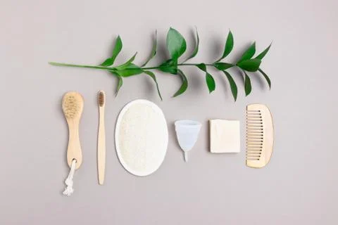 Layout of green leaves and zero waste accessories for personal hygiene. Stock Photos