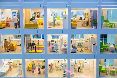 Layout of a large city polyclinic, models of rooms with equipment and people. Stock Photos