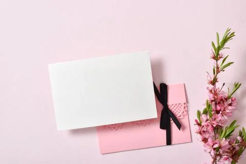 The layout is made of a white sheet and a pink envelope and a delicate branch of Stock Photos
