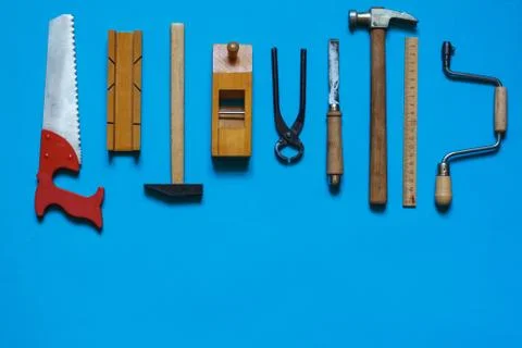 Layout of mini carpentry tools on a blue background, top view Stock Photos