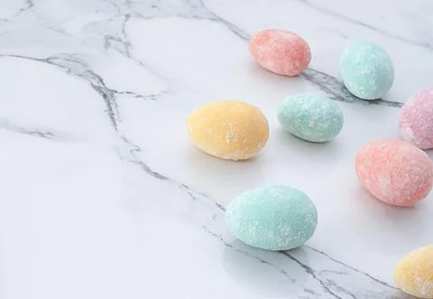 Layout of multi-colored Easter eggs, on a marble table. Soft focus. Close-up. Stock Photos