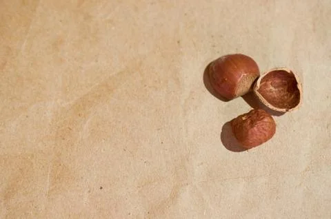 Layout of peeled kernels and hazelnut shells on a brown background Stock Photos