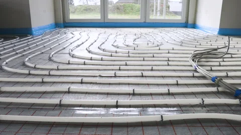 Layout of pipes for hydronic underfloor heating inside a building Stock Footage 235937673