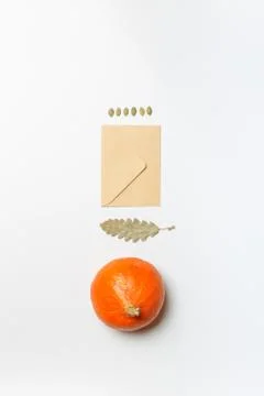 Layout with a small orange pumpkin, dry leaves and a letter in an envelope. On a Stock Photos
