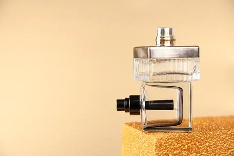 Layout stack of two unbranded perfume bottles on golden podium Stock Photos