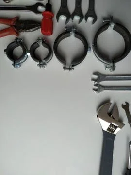 Layout of tools for plumbing repairs on a white background Stock Photos