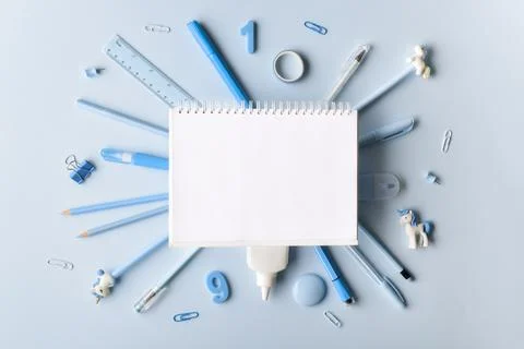 Layout of a white notebook on a stationery background on a light blue backgro Stock Photos