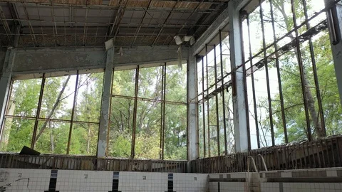 Lazurny pool with a view from the windows of the abandoned city of Pripyat Stock Footage 128366732