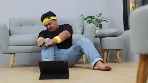 Lazy Asian overweight man doing fitness at home Stock Footage 342228317