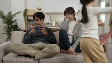 Lazy dad playing mobile game ignoring family Video stock 172252217
