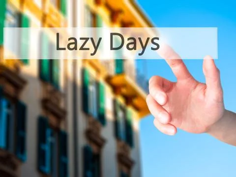 Lazy Days - Hand pressing a button on blurred background concept . Business,  Stock Photos
