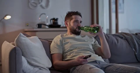 Lazy man lying on sofa and watching TV Stock Footage 271160946