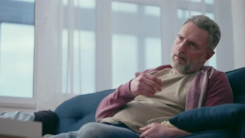 Lazy middle-aged man eating popcorn while watching movie at home, midlife crisis Stock-Footage 207190900