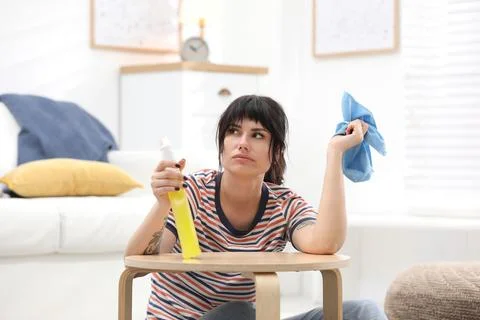 Lazy woman procrastinating while cleaning at home Stock Photos