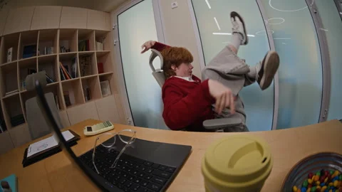 Lazy Young Ginger Haired Man Having Fun and Procrastinating at Work Stock Footage 343703927