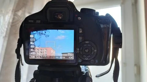 LCD display of a DSLR digital camera taking picture of a clouds fixed on a tr Stock Photos