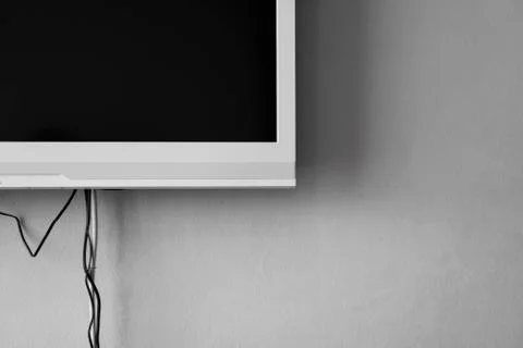 LCD or LED tv screen hanging on the wall with a tv tuner in room for interior Stock Photos