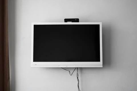 LCD or LED tv screen hanging on the wall with a tv tuner in room for interior Stock Photos