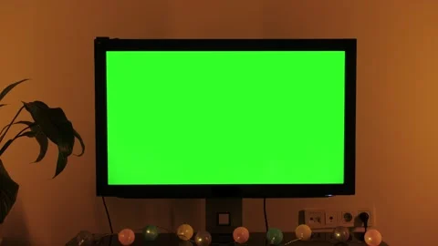 LcD smart TV screen with a blank green background in the living room. Chroma key Stock Footage 245349895
