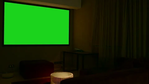 LcD smart TV screen with a blank green background in the living room. Media Stock Footage 246229922