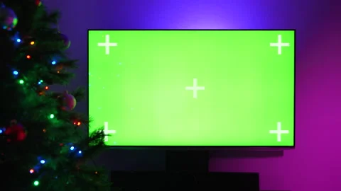 LCD TV With Track Green Screen. Glowing Christmas Tree In The Foreground. Video stock 213811473