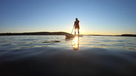 LD Low angle wide shot of a woman on a SUP at sunset Stock Footage 136049115