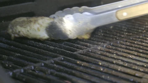 LD Taking the last leg of a chicken off the grill Stock Footage 160147164