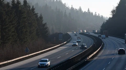 LD Traffic on a highway surrounded by spruce forest Stock Footage 123608680