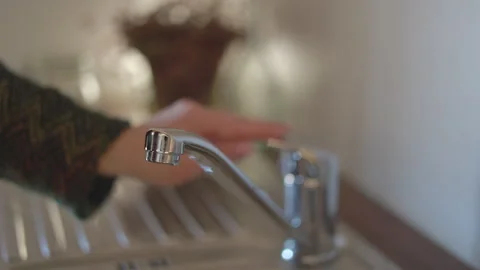 LD Water dripping from the kitchen tap and female hand closing it Stock Footage 264808435
