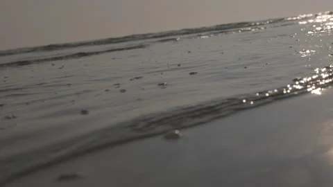 LD Waves gently licking the sandy beach at sunset Stock Footage 233991727