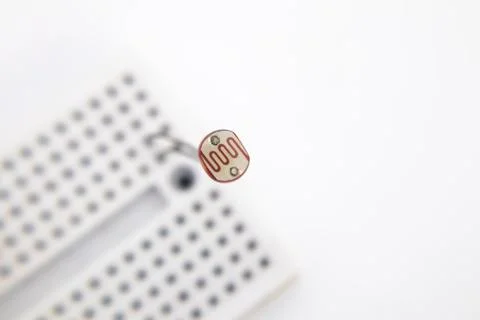 An LDR (Light Dependent Resistor) embedded in a project board on a white back Stock Photos