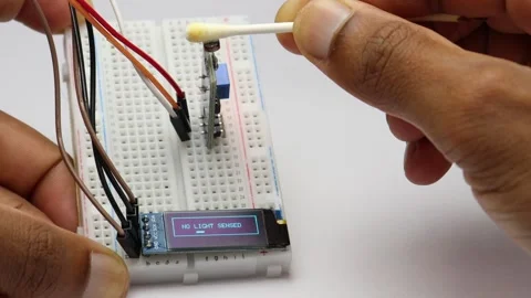 LDR sensor module working with OLED display showing light status Stock Footage 339018095