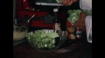 At le Grand Vefour restaurant, chef, lettuce salad in the kitchen, Paris, 1970 Stock Footage 85875722