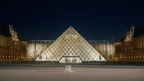 The Le Louvre Pyramid lights up the night sky in Paris, France Stock-Footage 303451614