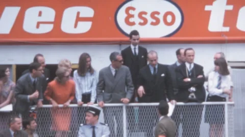 Le Mans - 1967: Spectators watch the race from the tribune, Esso banner hangs Stock Footage 280177579
