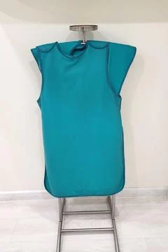 Lead apron hanging on hanger. Protective clothing for patient during dental x Stock Photos