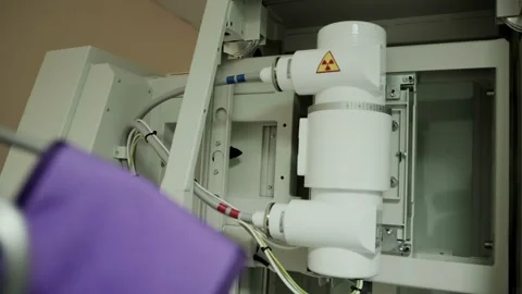 Lead aprons in the X-ray room against the background of the X-ray unit in the Stock Footage 317807248