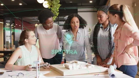 Lead architect leaning in, pointing at model, starting plan review while SPECTRA Stock Footage 333539825