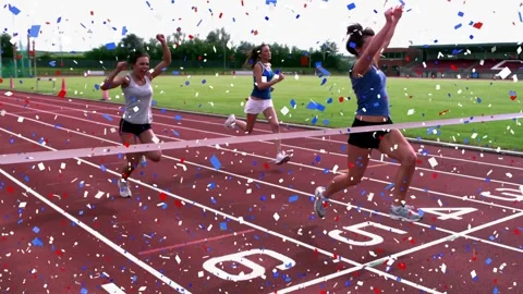Lead in blue breaking finish tape, sparking confetti as others racing on track Stock Footage 329533743