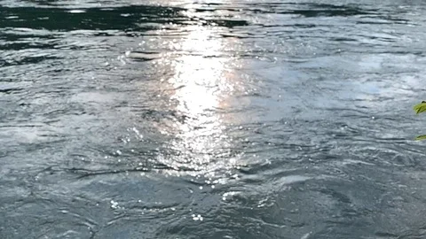 Lead colored stream reflecting sunlight 스톡 동영상 113861754