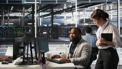 Lead data center technician overseeing team integrating AI automation in rigs Stock Footage 309638636