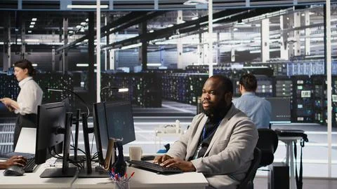 Lead data center technician overseeing team integrating AI automation in rigs Stock Photos