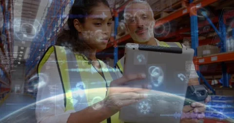 Lead demonstrating scanner and coaching tablet operator in warehouse while AR Stock Footage 329929286