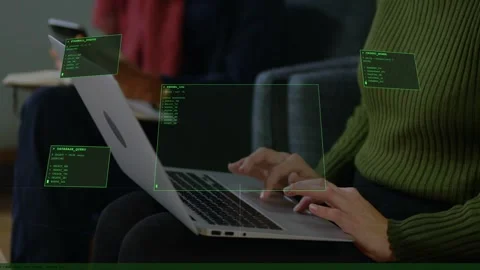 Lead dev typing initiating HUD panels overlaying laptop screen for tech work, Stock Footage 333287955