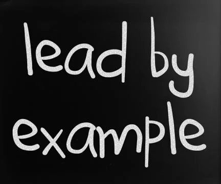 "lead by example" handwritten with white chalk on a blackboard Stock Illustration