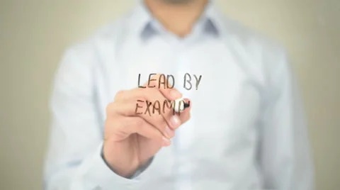 Lead by Example , Man writing on transparent screen Stock Footage 62867810